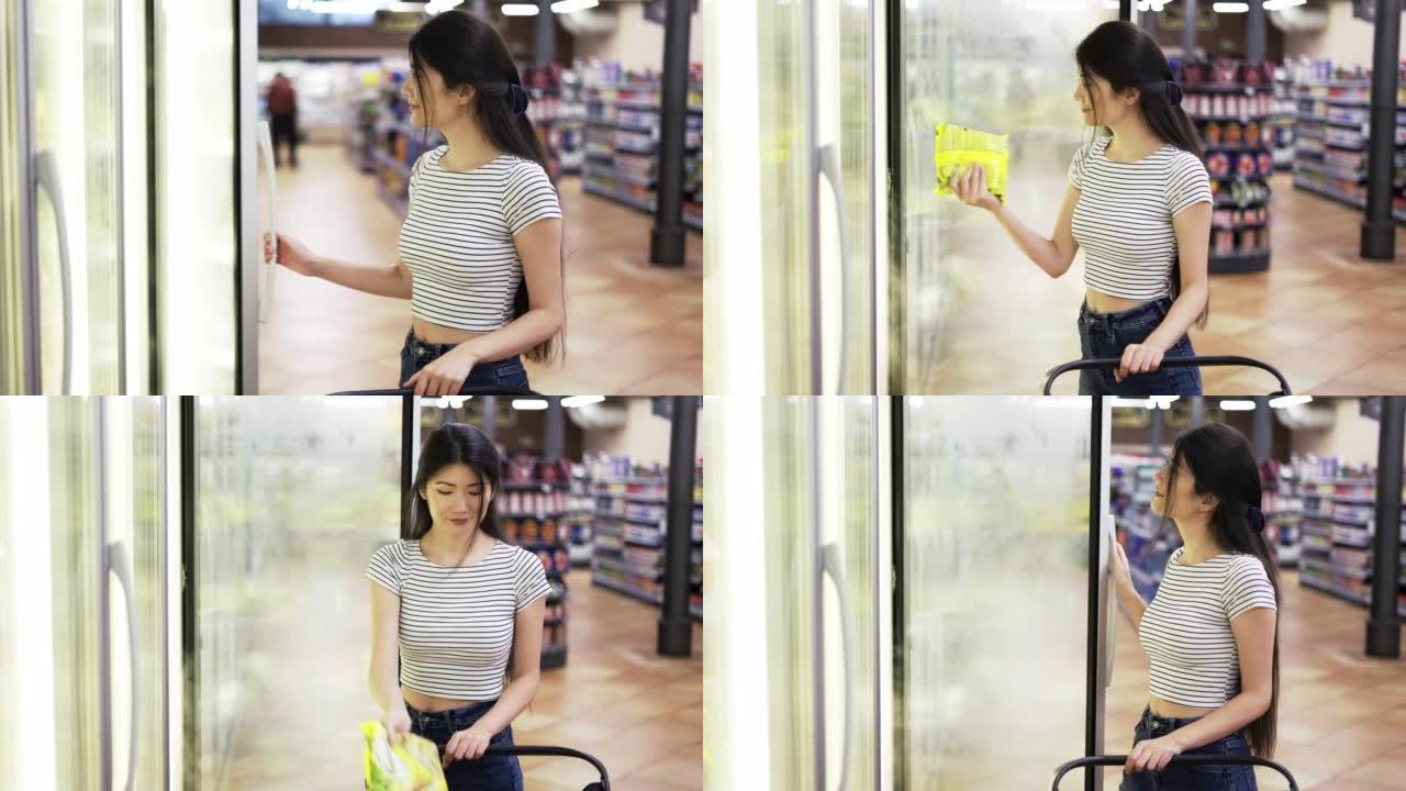 一位亚洲女孩游客选择一种产品。快乐的商店访客。商店里的产品选择
