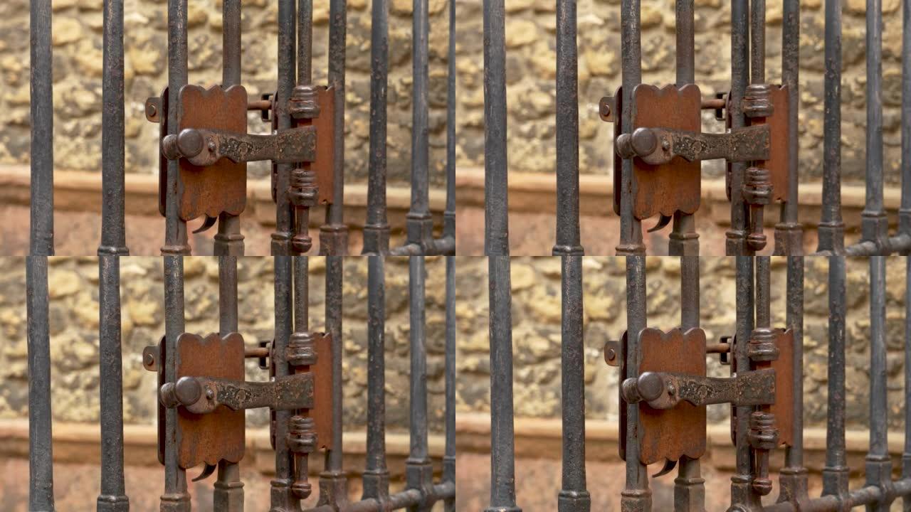 古代金属生锈的锻造手柄锁舌 (闩锁) 古董大教堂格子门的关闭门