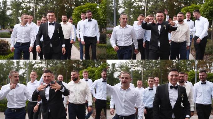 新郎在婚礼当天展示和与伴郎散步的乐趣。穿着黑色西装，领结和胸裤的快乐优雅男人与朋友聚会，并在公园的相