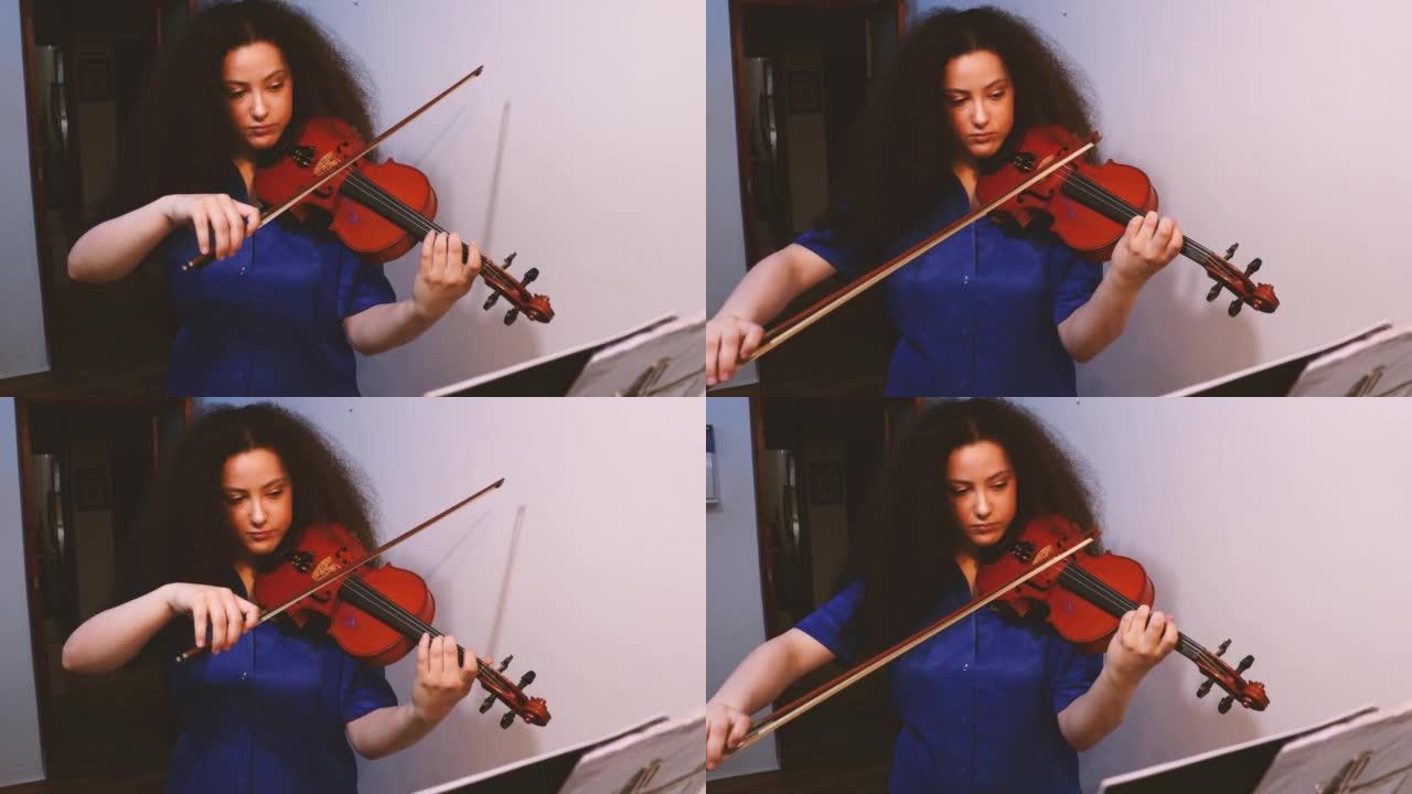 女孩小提琴家在家里演奏小提琴音乐会。古典音乐概念。