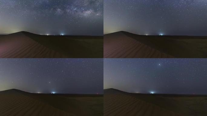 银河和月亮从沙漠中的沙丘随滑块运动的4k时间流逝。