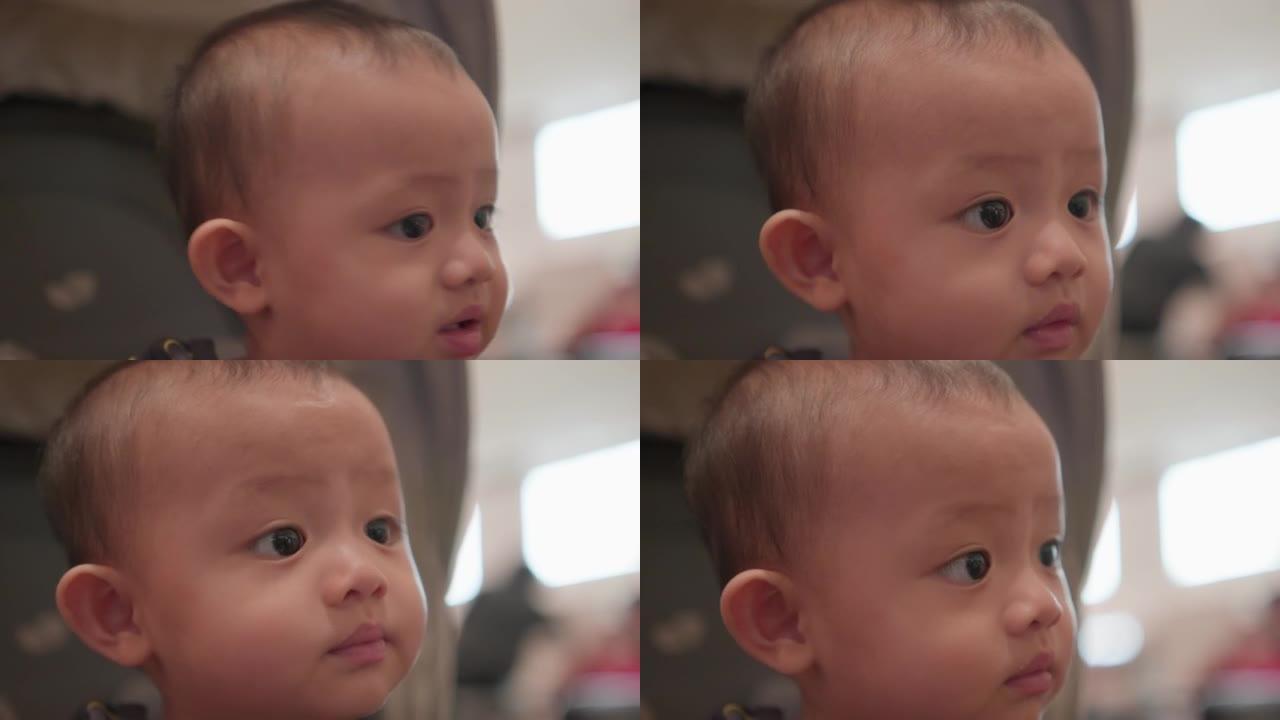 4k视频，脸部可爱亚洲新生男婴的特写肖像看着相机。