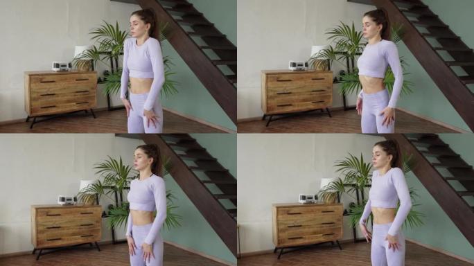 年轻女子在家做体操。一个穿着紫色西装的女人揉肩膀和脖子。体操，练习