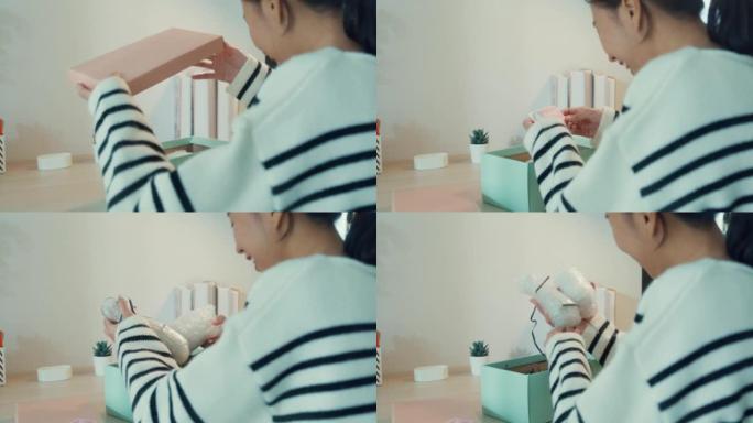 特写镜头年轻的亚洲女孩穿毛衣收到礼物开盒薄荷粉色粉盒从玻璃商店，桌子上有快乐的时刻。