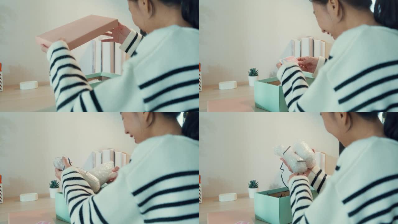 特写镜头年轻的亚洲女孩穿毛衣收到礼物开盒薄荷粉色粉盒从玻璃商店，桌子上有快乐的时刻。