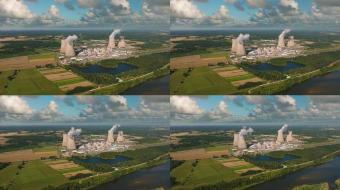 核电站周围的空中全景飞行。二氧化碳排放，烟雾和蒸汽的能量。生态与自然污染。