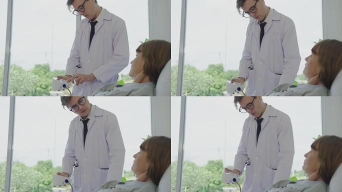 男性医生用血压计检查成熟的女性。