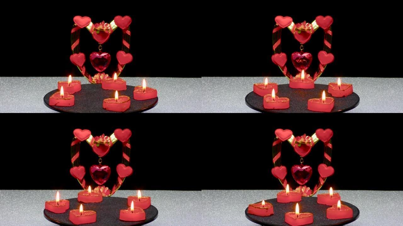 在浪漫的心构成的背景下，燃烧五支蜡烛旋转
