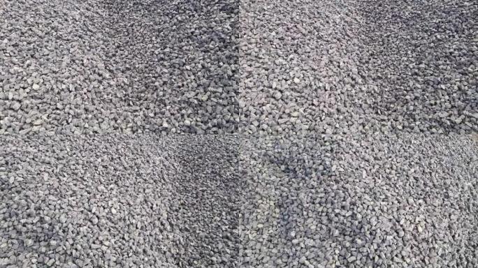 在建筑工地拍摄黑色和灰色碎石Kapchi (骨料破碎机石粉) 的特写镜头。Camere从右向左移动