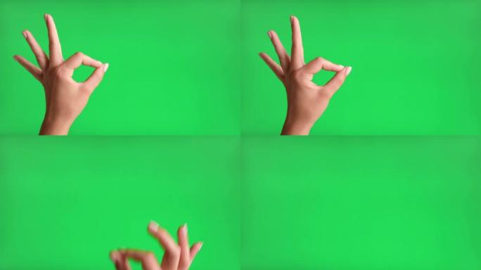 女人在色度键背景下用手示意好课。特写。一切都很好。女性手在绿色屏幕上做OK手势。4k素材包。批准好。