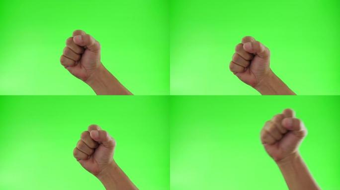 双手举起紧握的拳头在绿色屏幕背景上