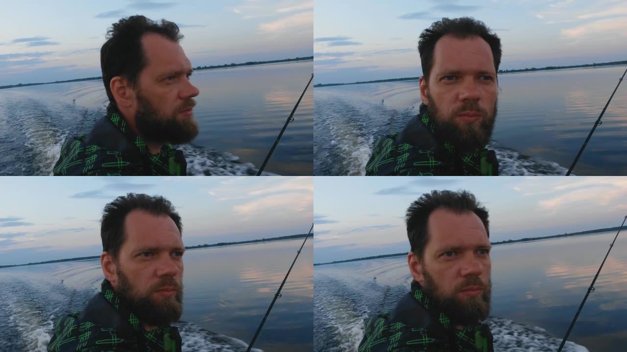 一个留着胡子的高加索中年男子晚上在河上驾驶摩托艇。