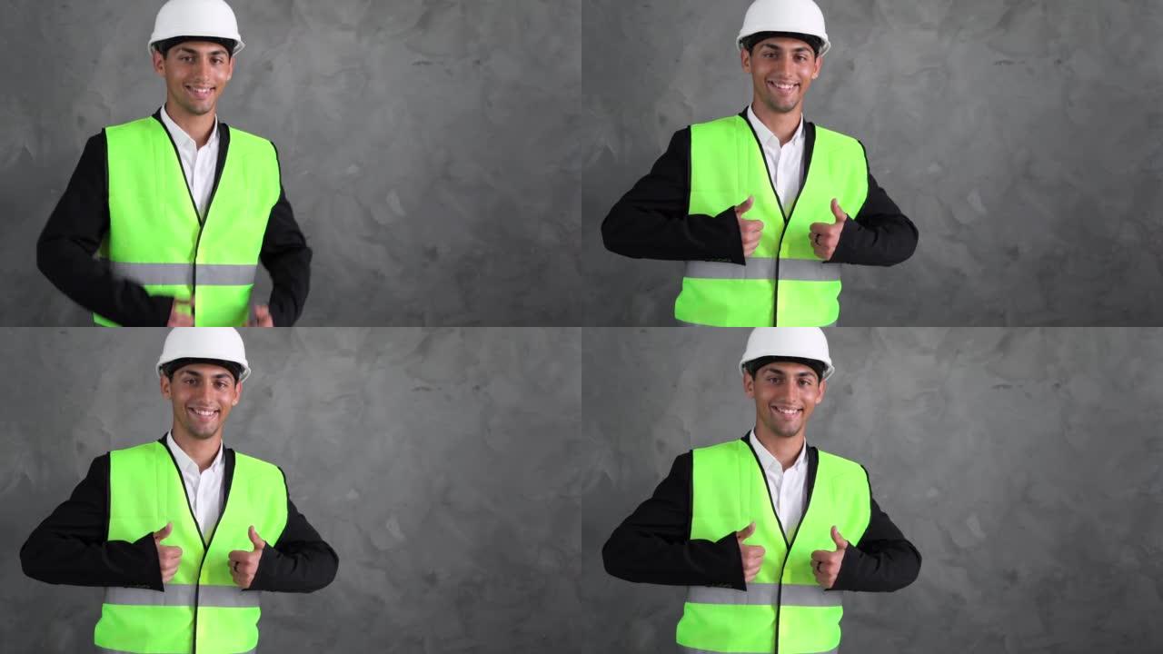 阿拉伯语施工经理。男工程师伸出手指微笑。建筑的建筑师。穿着建筑工人制服的男人。建筑公司的员工