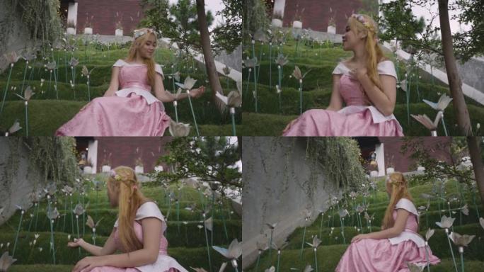 一位穿着粉红色连衣裙的公主独自一人在花园里玩郁金香花