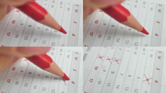 月数日历被删掉了。男性用红笔在纸质日历上写下这一天。日历上非常重要的日期。在日历上签名日期