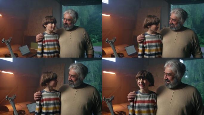 Happy grandfather and grandson laughing at joke in