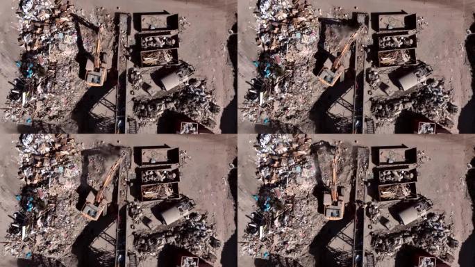 垃圾填埋场上的挖掘机原木抓斗起重机。建筑垃圾或杂物的回收。二级生。