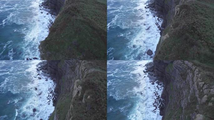 无人机占领了Isla的山丘边缘，蓝色的坎塔布连海也从高处击中了岩石