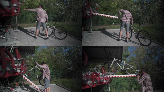自行车基础设施。一名男子在德国慕尼黑使用双层自行车停车场。男性将自行车停在双层自行车停车场。欧洲的现