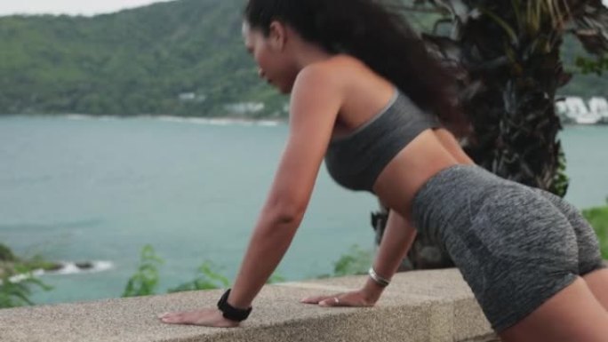 亚洲妇女在夏日用俯卧撑在户外锻炼