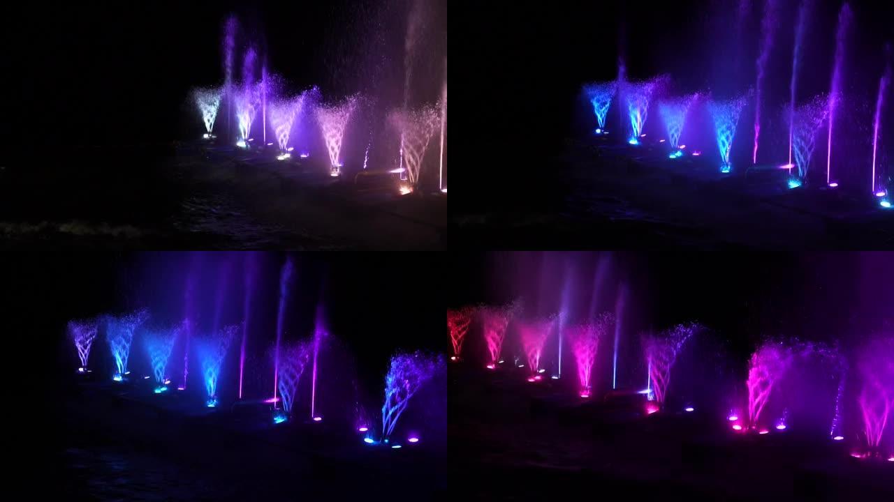 水厂在水面上的夜晚，通过点灯装饰和播放颜色。