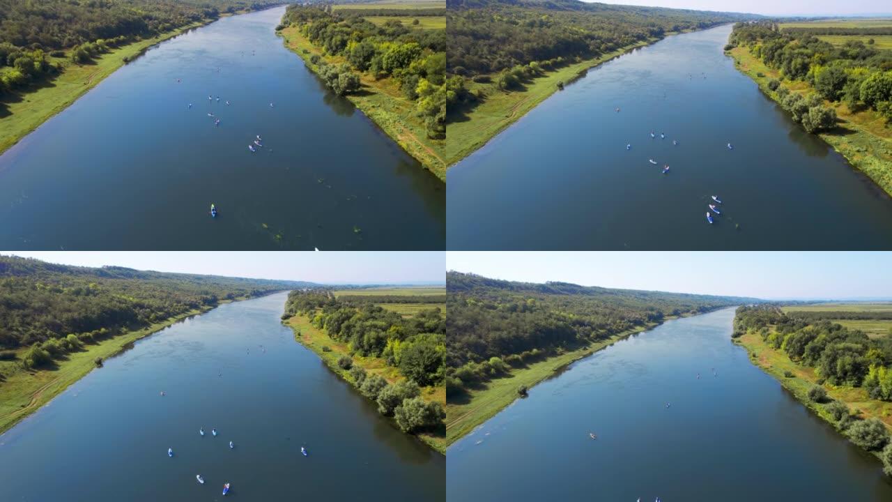 在摩尔多瓦的德涅斯特 (Dniester) 上进行站立桨板运动的多人的空中无人机视图。垂直视图