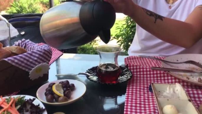 pouring tea into glass slow motion