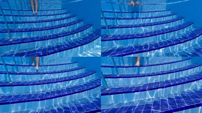 水下摄影。太阳的光线照亮了一个巨大的室外游泳池中的水柱。太阳的光线在水池底部形成图案。梯子台阶。