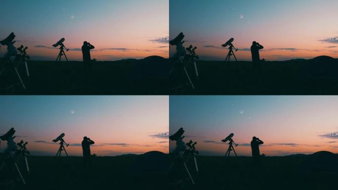 用天文望远镜，天文摄影机和双筒望远镜观察夜空的人。