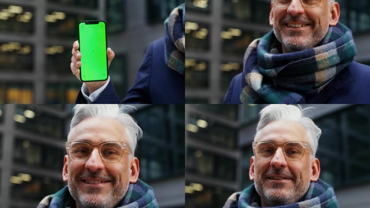 一个穿着暖和的男人拿着绿屏电话