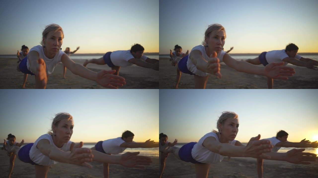 小组人做瑜伽战士姿势连贯海边日出快速慢动作