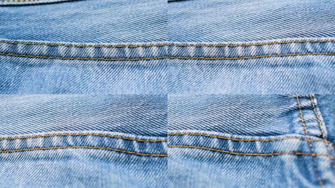 浅蓝色牛仔裤上的特写接缝。蓝色牛仔布纹理背景