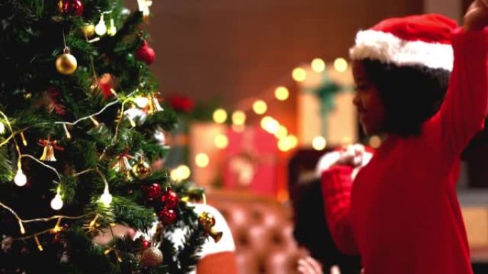 即将到来的圣诞节，父亲母亲和女儿一起装饰圣诞树。