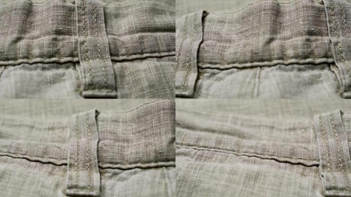 亚麻面料裤子上的元素。天然亚麻织物纹理背景