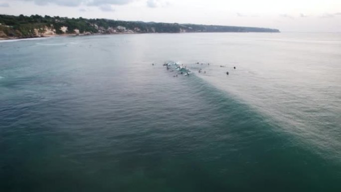 一群冲浪者抓住波浪，在波浪崩溃之前做很短的骑行