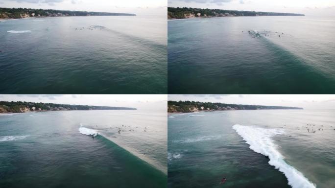 一群冲浪者抓住波浪，在波浪崩溃之前做很短的骑行