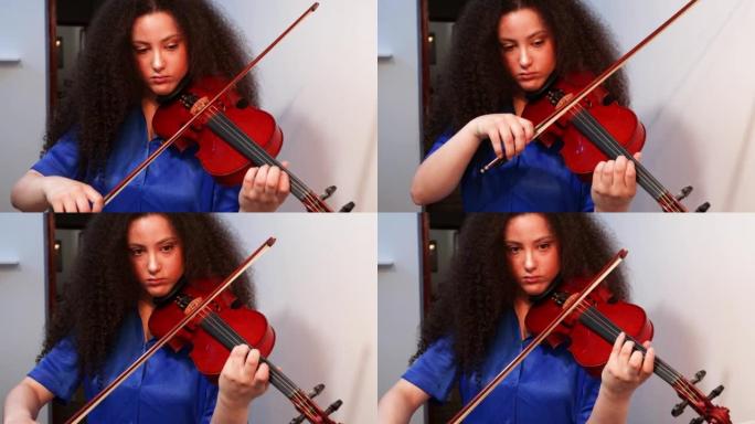 女孩小提琴家在家里演奏小提琴音乐会。健全的概念。