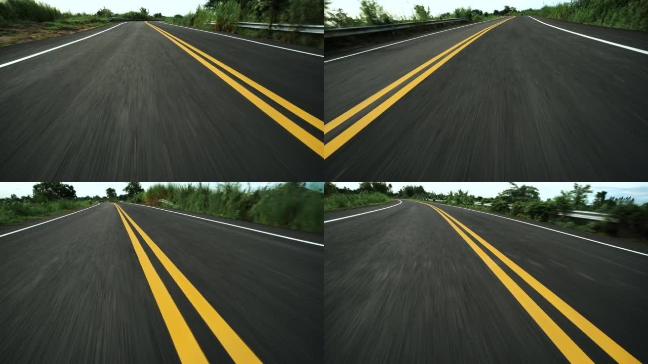 高速汽车在沥青路面上行驶的前pov视图与双黄线汇合
