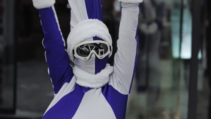 Clown dressed up as snowman dances at event show. 