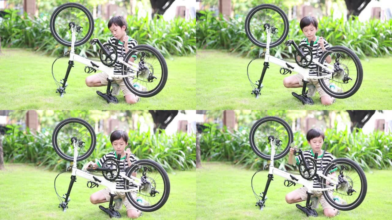 男孩修理自行车喷涂机械齿轮