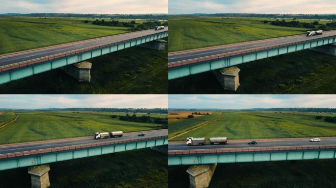 带汽油箱拖车的货车在高速公路上通过桥梁快速行驶，并提供货物鸟瞰图
