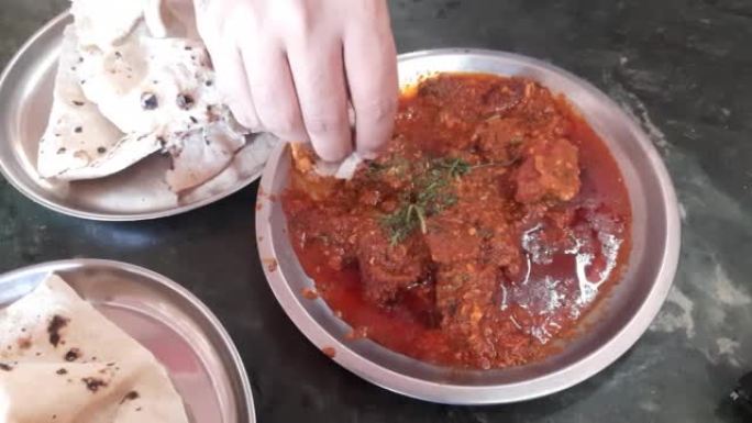 Bhuna Gosht羊肉masala或印度羊肉咖喱是正宗的印度辣羊肉肉汁菜肴。用印度香料烹饪。帕塔