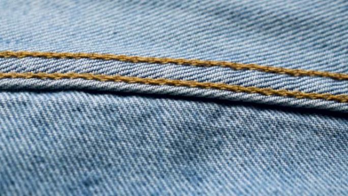 Closeup inseam on a light blue jeans. Blue denim t