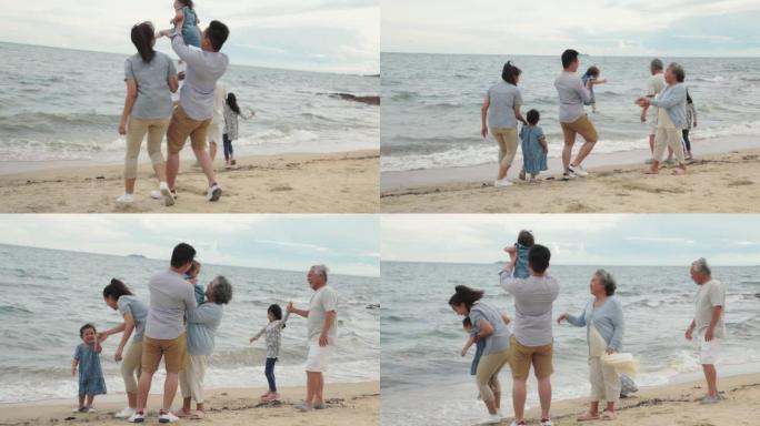 许多年龄段的亚洲家庭在海边的海滩上放松。玩沙滩的孩子。