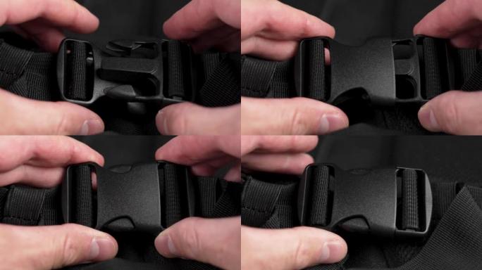 Locking black plastic clasp on nylon backpack stra