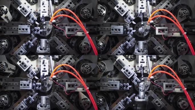 机器人自动机正在制造弹簧，CNC线圈孢子制造机，操作员在工厂制造汽车弹簧零件。