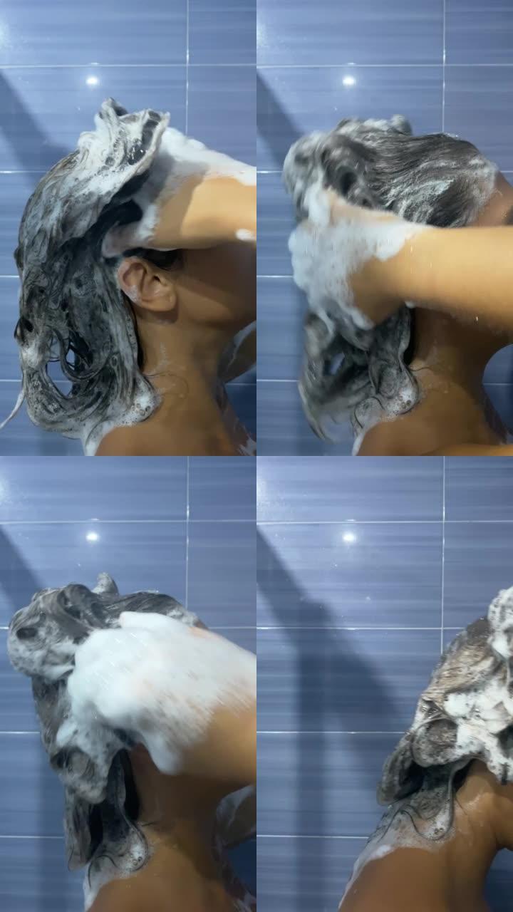 淋浴中的女人在用泡沫洗发露将头发涂满泡沫后冲洗头发。一个小女孩在淋浴时用慢动作从头发上取下肥皂的垂直