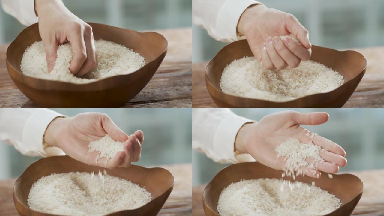 女性手感干净的生米和米饭滑落到木碗中