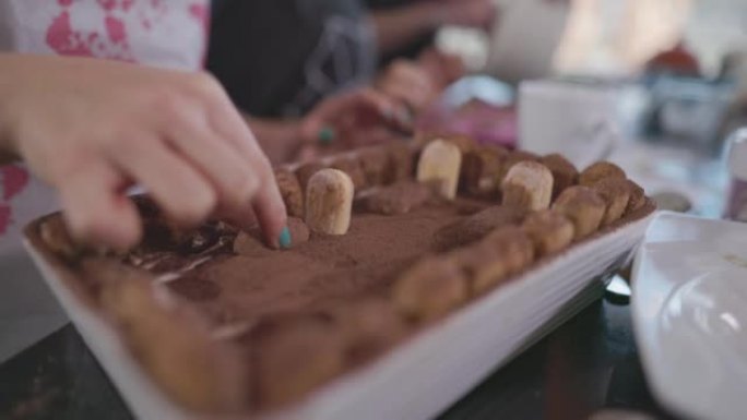 Teenage girl preparing Halloween tiramisu for the 