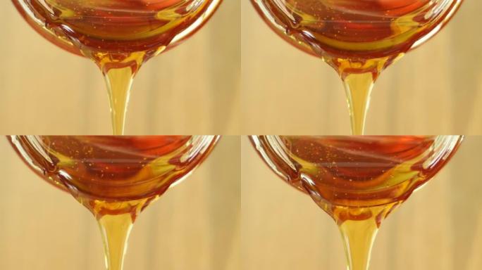 从玻璃罐中倒出蜂蜜的特写镜头。健康美容产品可持续生活理念。